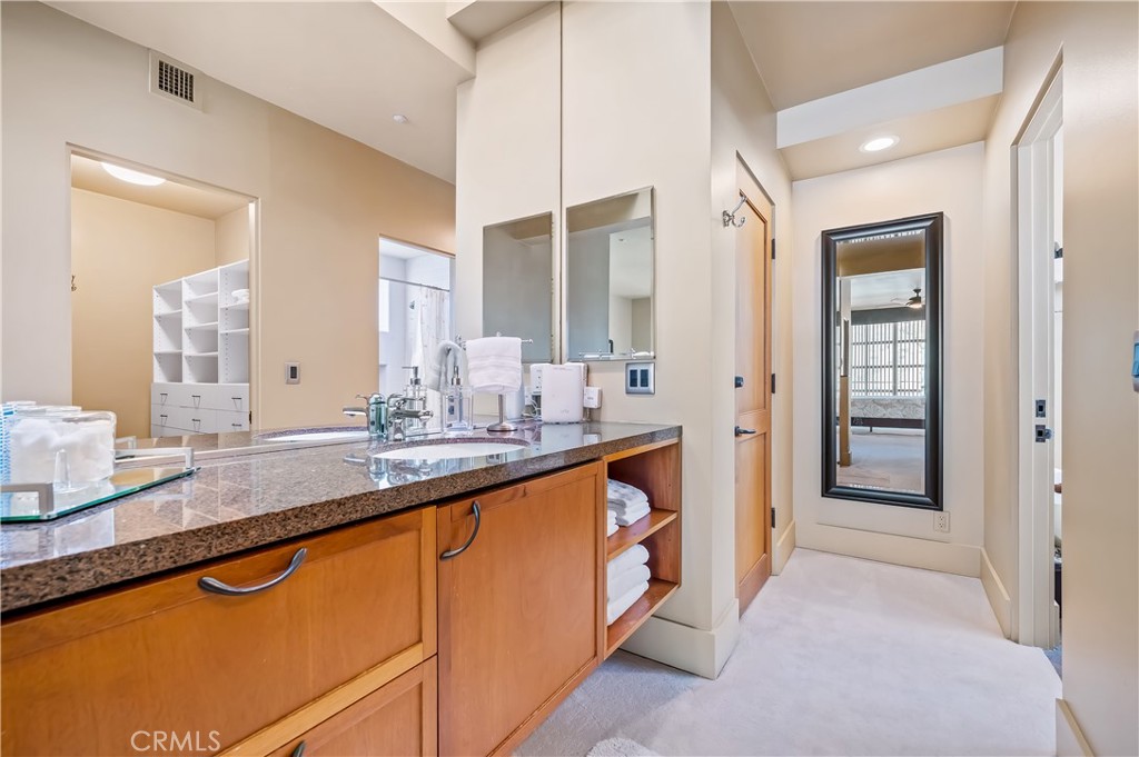 35121 Beach Road Dana Point, CA 92624 - Photo 41 of 46 a bathroom with a granite countertop sink and a mirror