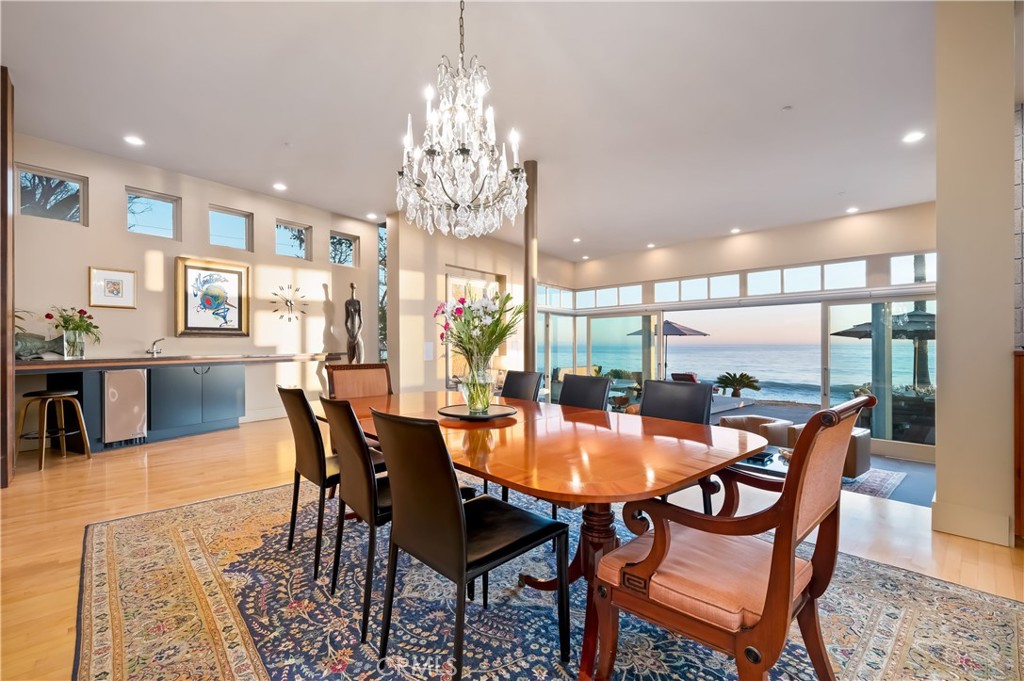 35121 Beach Road Dana Point, CA 92624 - Photo 8 of 46 a dining room with furniture a chandelier and wooden floor