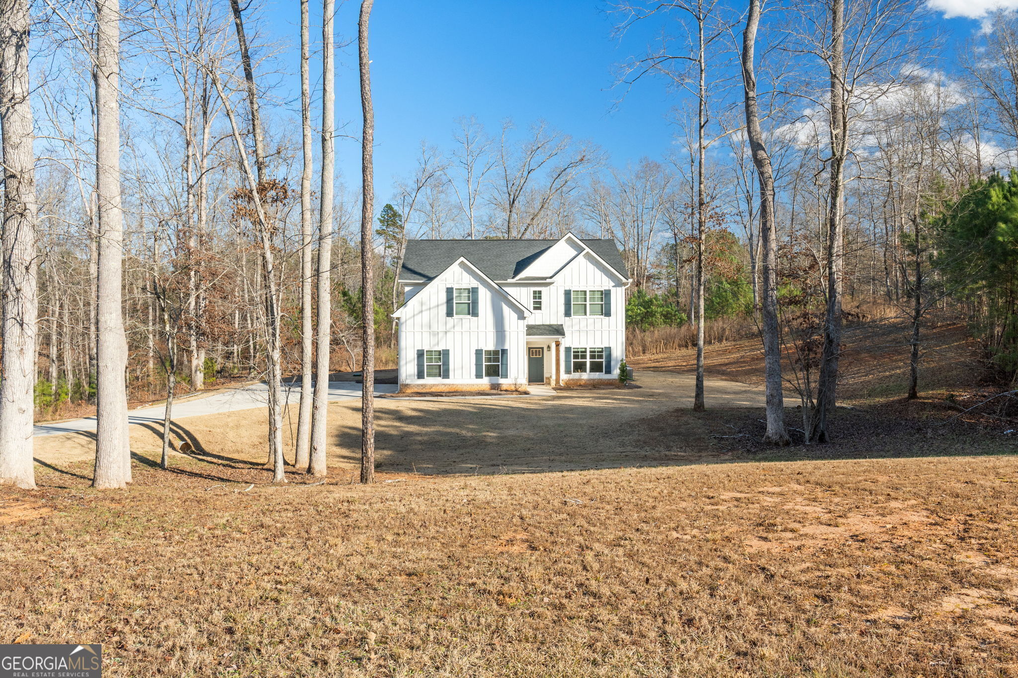 a view of white house with a yard