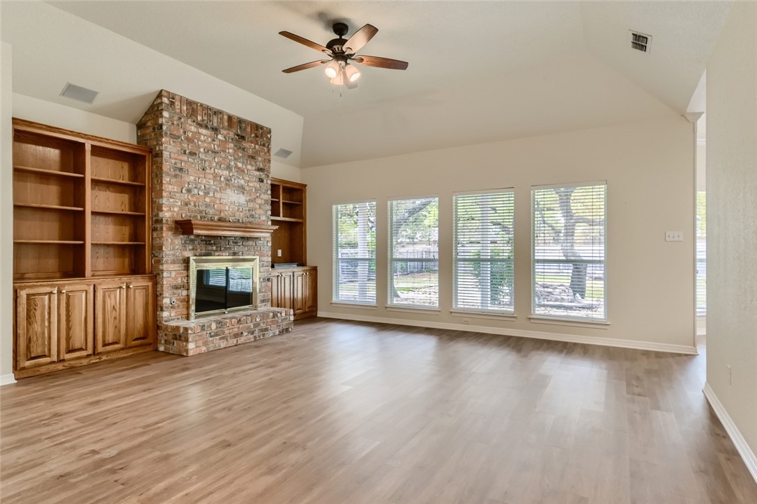 511 Susana Drive Georgetown, TX 78628 - Photo 4 of 31 Living room featuring vinyal plank flooring, ceiling fan, and large windows