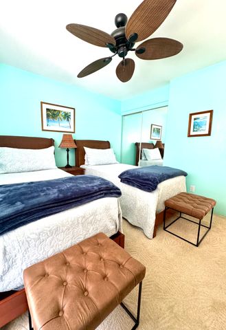 a bedroom with a bed and ceiling fan
