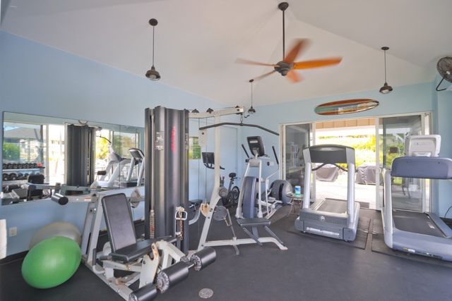 a room with gym equipment and windows