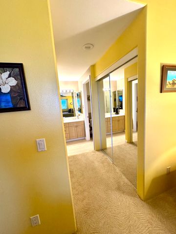 a view of a hallway with bathroom and a shower
