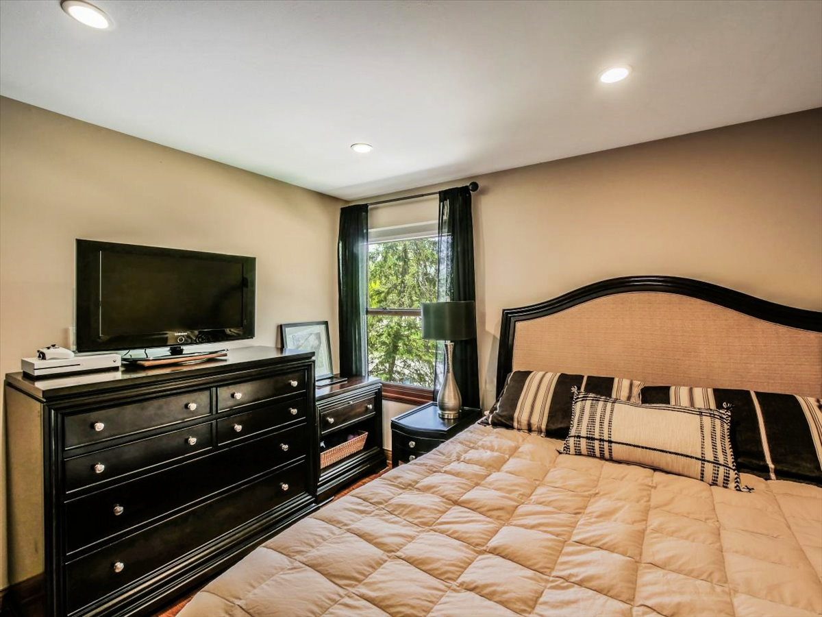 333 Rugby Place Schaumburg, IL 60169 - Photo 15 of 34 a bedroom with a bed and a flat screen tv