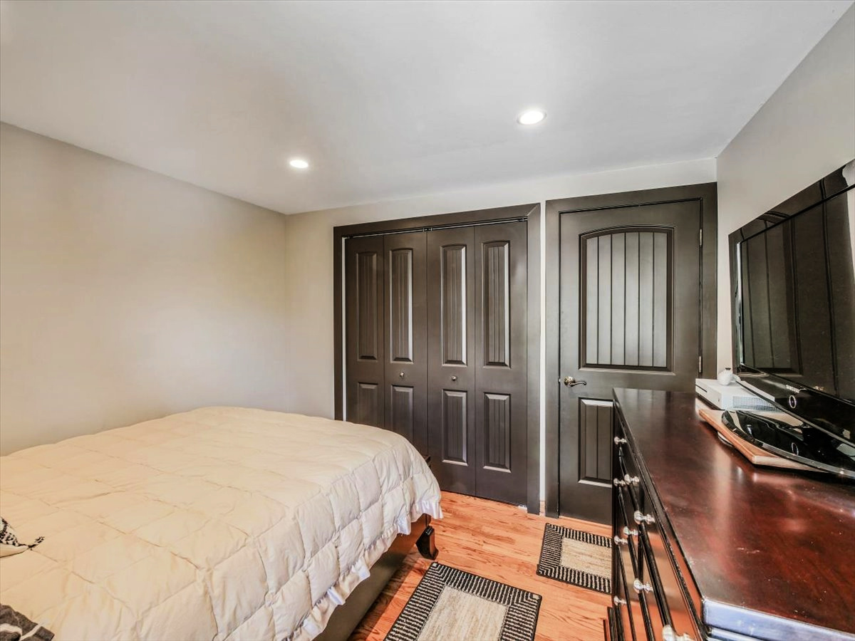 333 Rugby Place Schaumburg, IL 60169 - Photo 16 of 34 a bedroom with a bed and a flat tv screen on the dresser