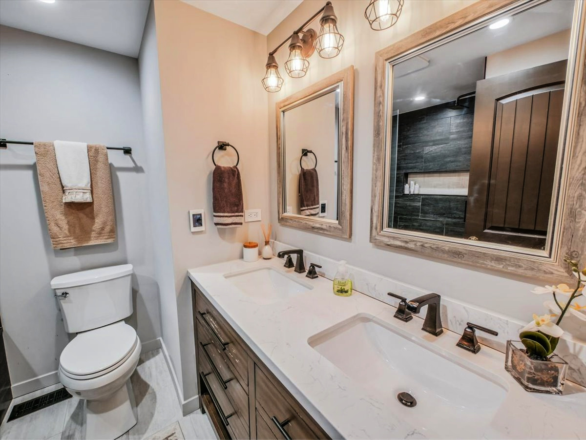 333 Rugby Place Schaumburg, IL 60169 - Photo 17 of 34 a bathroom with a toilet sink and mirror