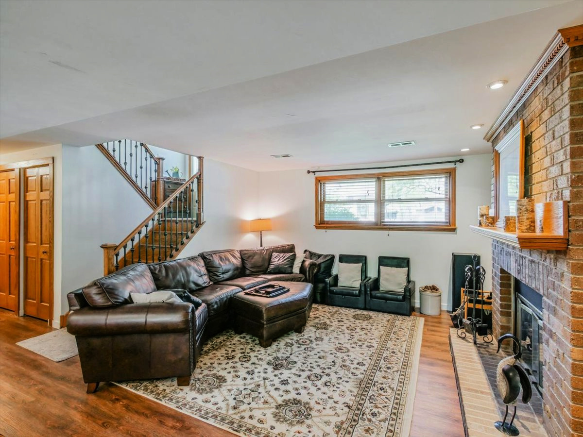 333 Rugby Place Schaumburg, IL 60169 - Photo 22 of 34 a living room with furniture fireplace and a window