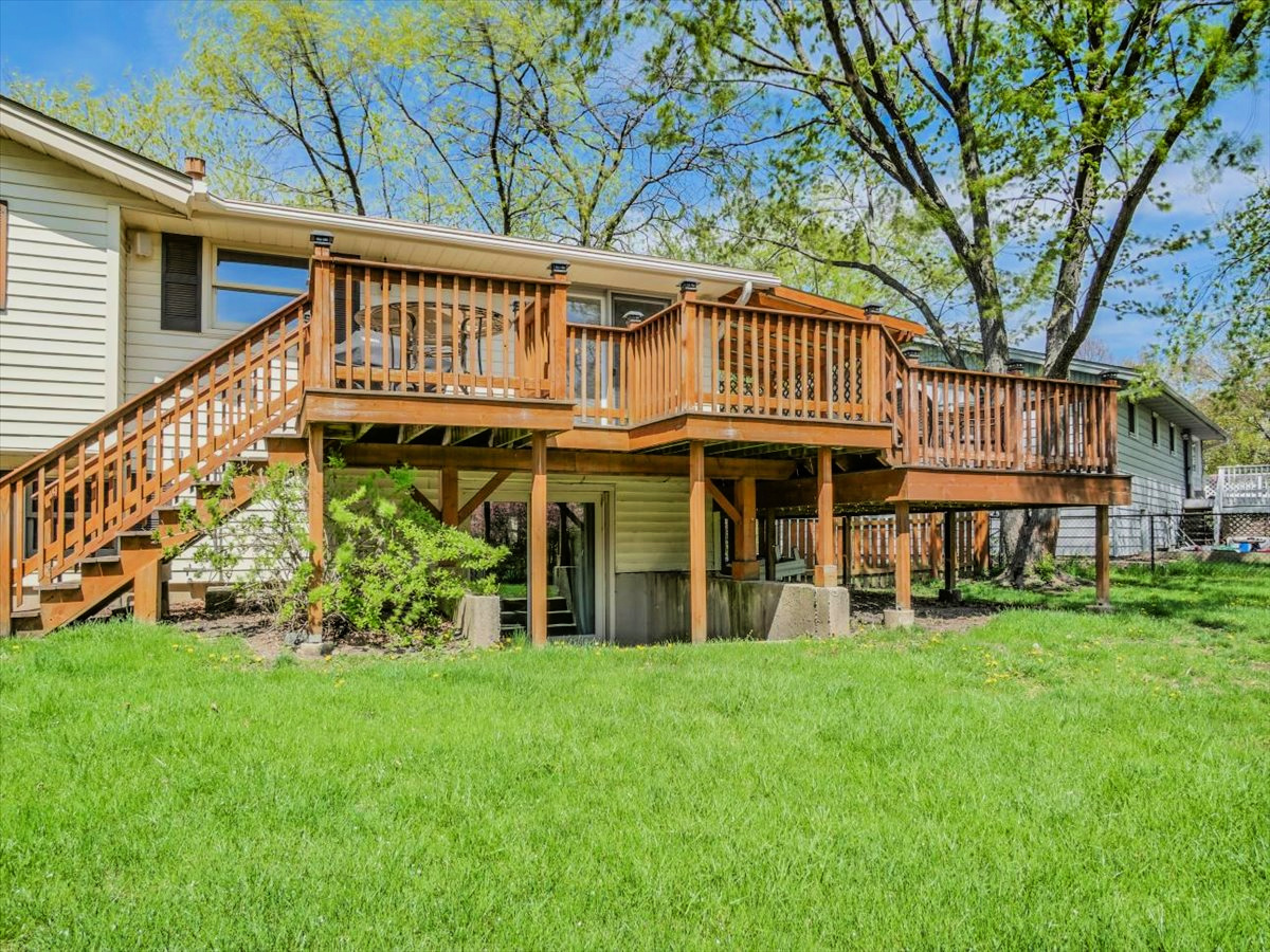 333 Rugby Place Schaumburg, IL 60169 - Photo 33 of 34 a view of a house with a large window and a yard with lawn chairs