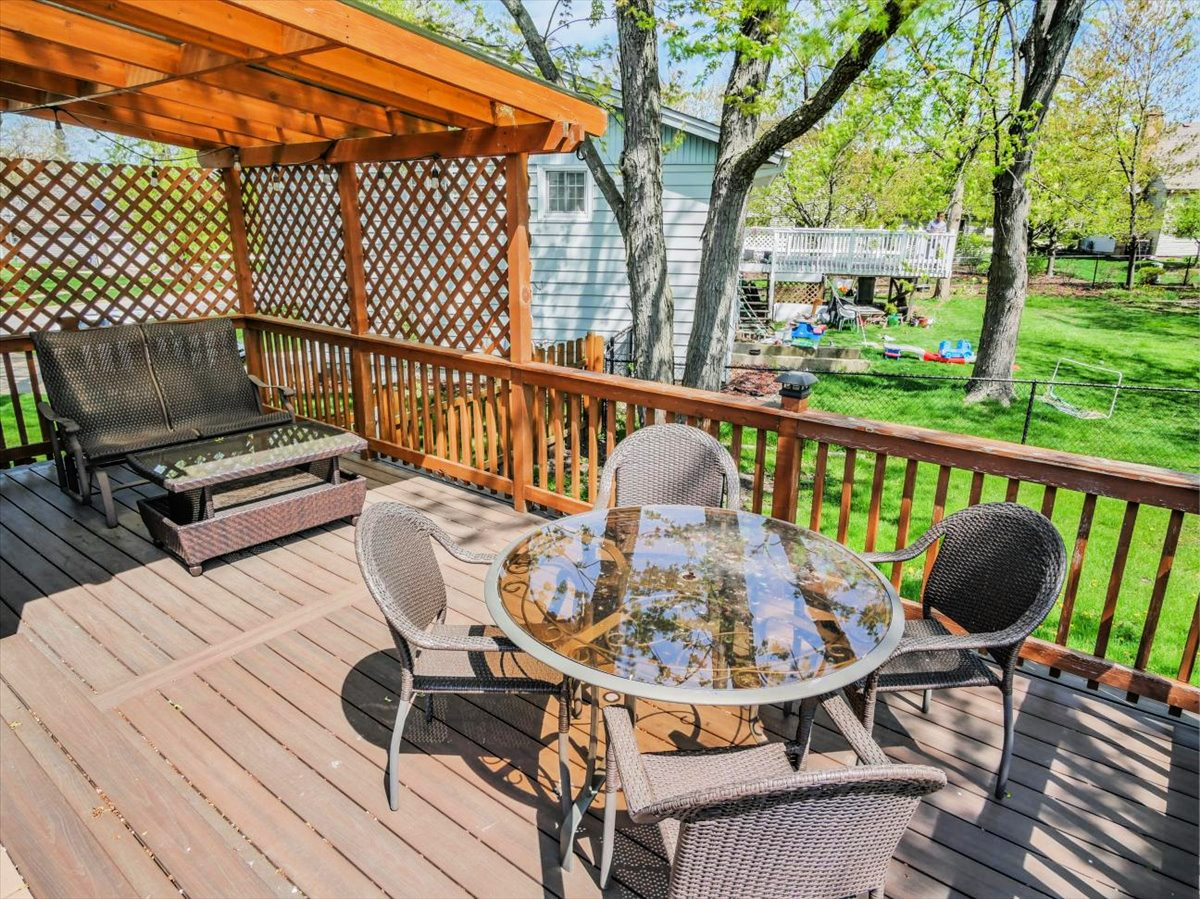 333 Rugby Place Schaumburg, IL 60169 - Photo 7 of 34 a view of a balcony with wooden floor and outdoor seating