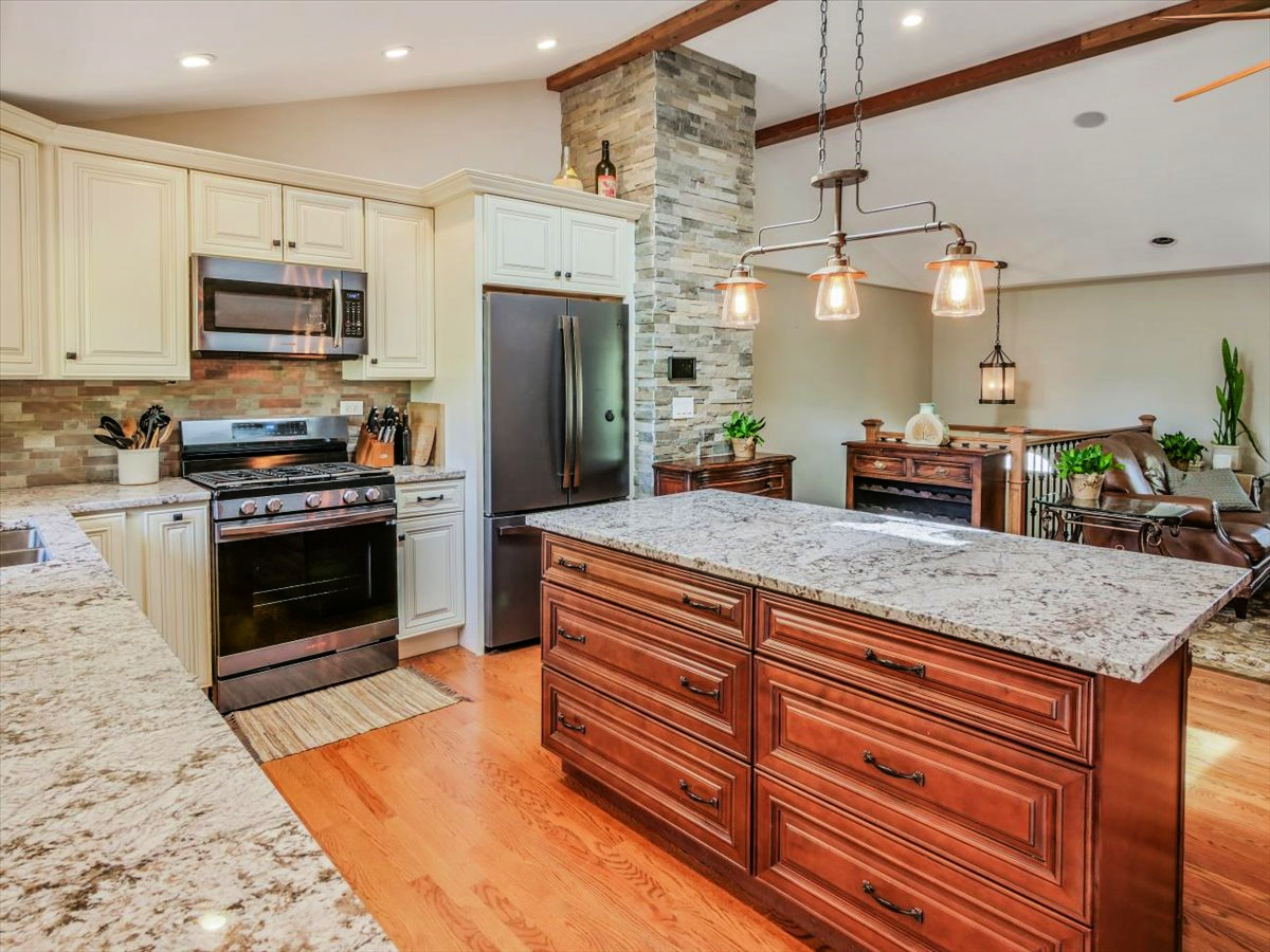 333 Rugby Place Schaumburg, IL 60169 - Photo 9 of 34 a kitchen with stainless steel appliances granite countertop a stove a sink and a microwave