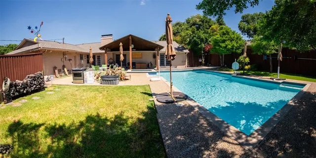 a view of a house with swimming pool and sitting area