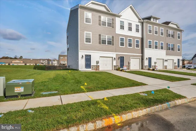 a front view of a building with a yard