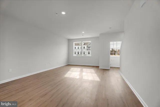 an empty room with windows and closet