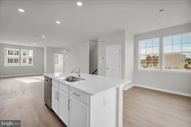 a kitchen with stainless steel appliances a sink stove and cabinets