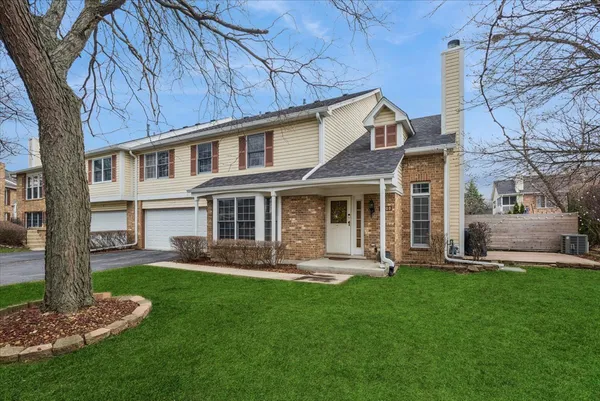 a front view of a house with a yard and sitting area