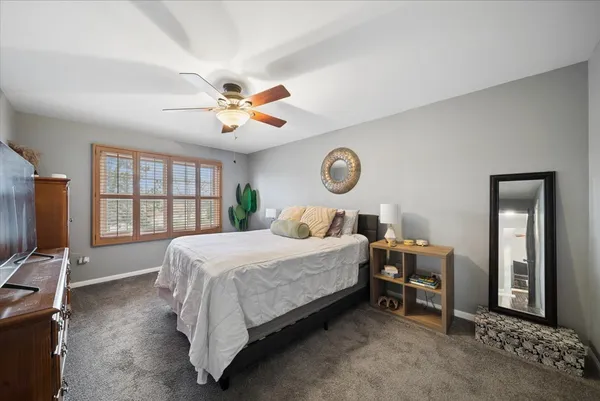 a bed room with a bed window and a chair