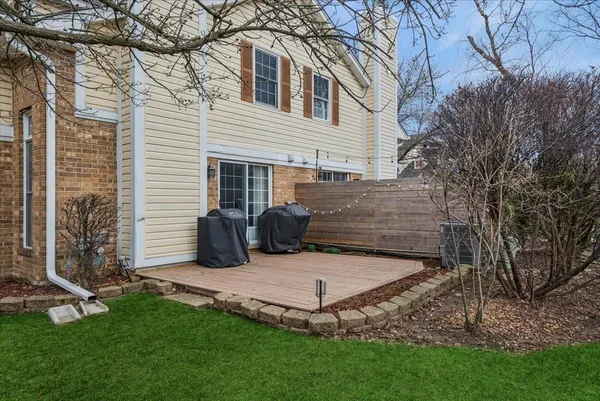 a view of backyard with a table and a large tree