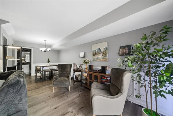 a living room with furniture potted plant and a window