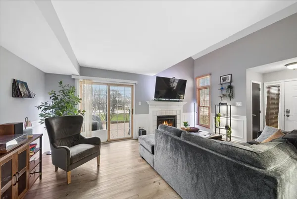 a living room with furniture fireplace and flat screen tv