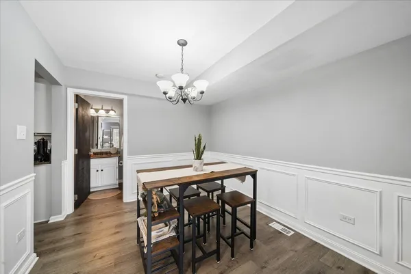 a view of a dining room with furniture and wooden floor