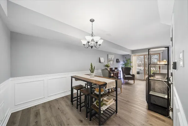 a view of a dining room with furniture and a chandelier