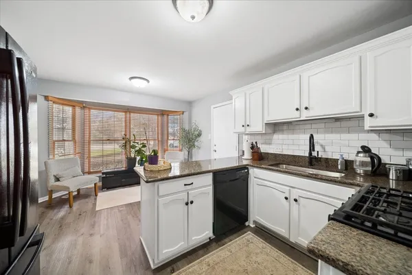 a kitchen with a sink stove and cabinets