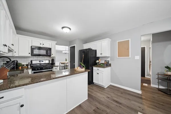 a kitchen with granite countertop stainless steel appliances and wooden cabinets