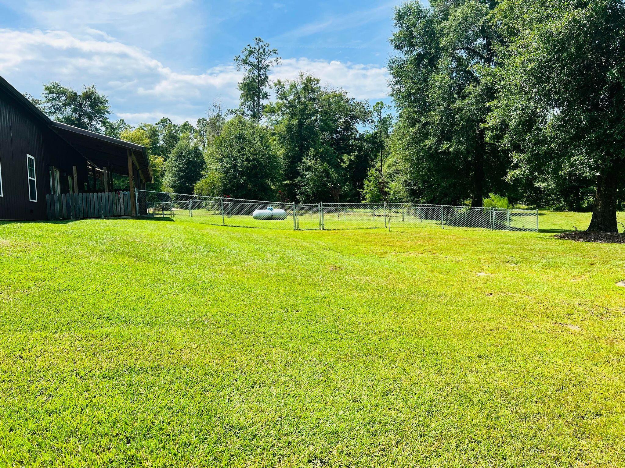 6389 Yellow River Ranch Road Florala, AL 36442 - Photo 17 of 30 a view of a swimming pool with an outdoor space and seating area