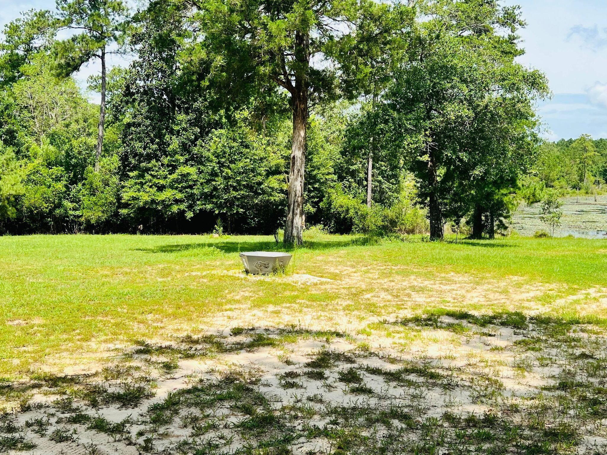 6389 Yellow River Ranch Road Florala, AL 36442 - Photo 29 of 30 a view of a swimming pool with an outdoor space and seating area
