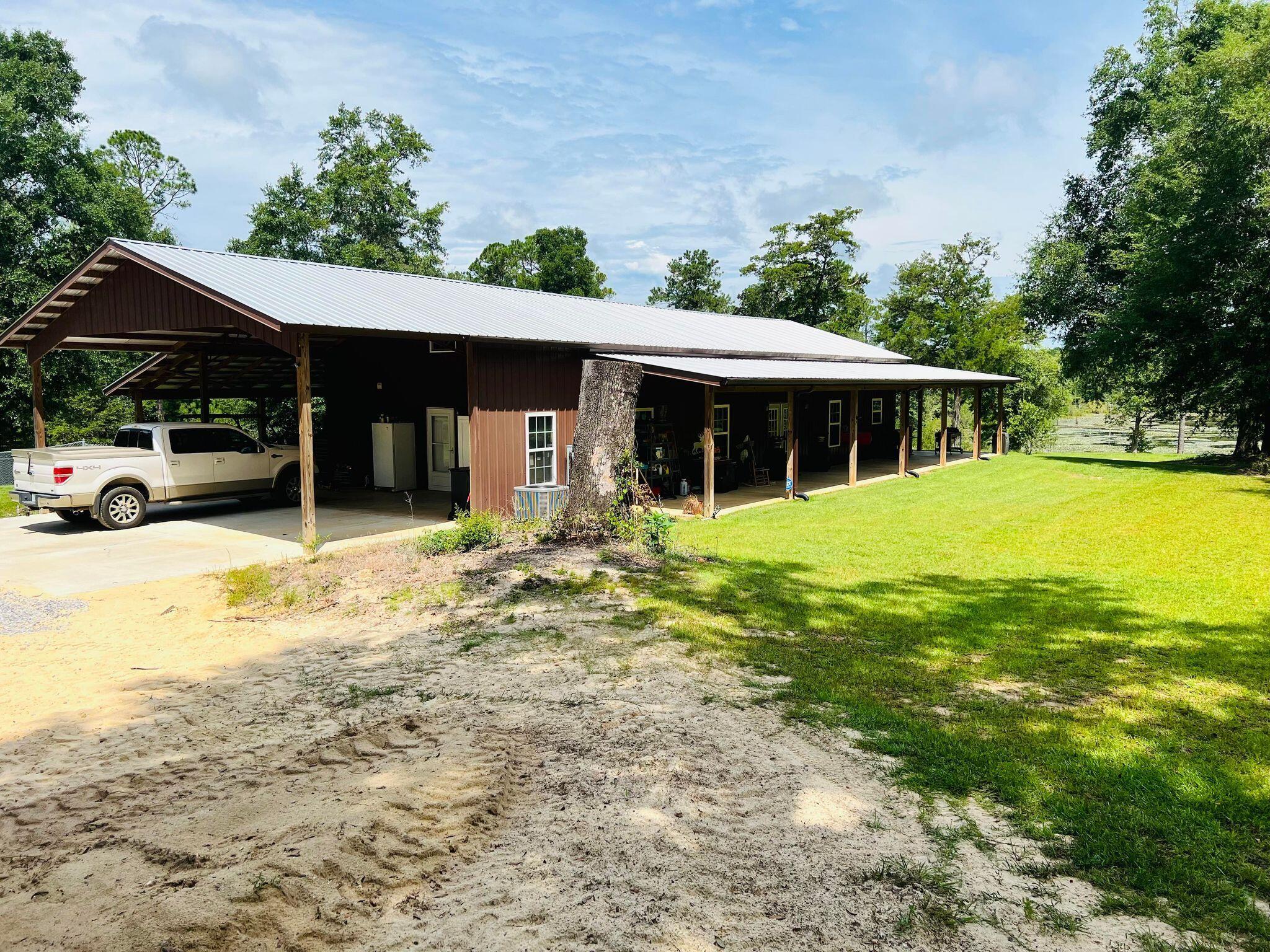 6389 Yellow River Ranch Road Florala, AL 36442 - Photo 3 of 30 a view of a house with a yard