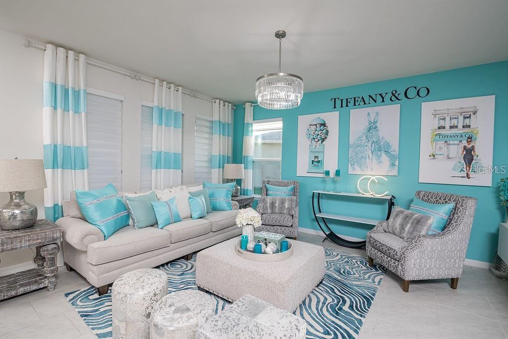 2937 Hooded Crane Cove Harmony, FL 34773 - Photo 16 of 58 a living room with furniture a chandelier and a large mirror