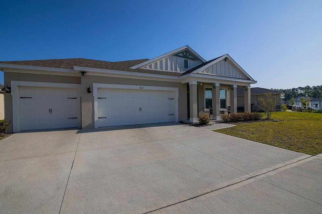 2937 Hooded Crane Cove Harmony, FL 34773 - Photo 2 of 58 front view of a house with a yard