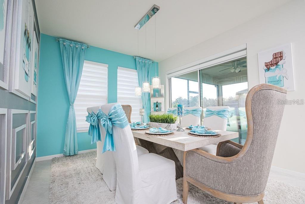 2937 Hooded Crane Cove Harmony, FL 34773 - Photo 24 of 58 a dining room with furniture window and outside view