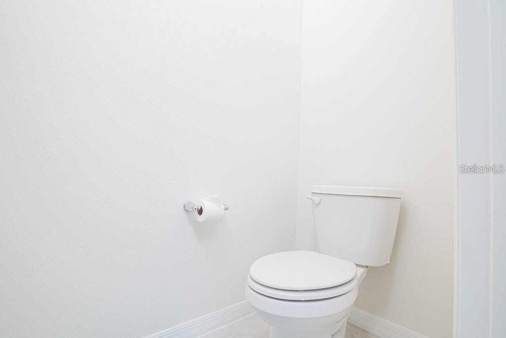 2937 Hooded Crane Cove Harmony, FL 34773 - Photo 36 of 58 a white toilet sitting next to a white wall