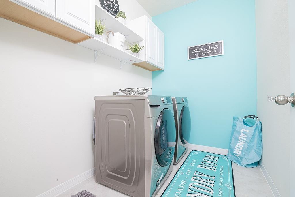 2937 Hooded Crane Cove Harmony, FL 34773 - Photo 38 of 58 a utility room with dryer and washer