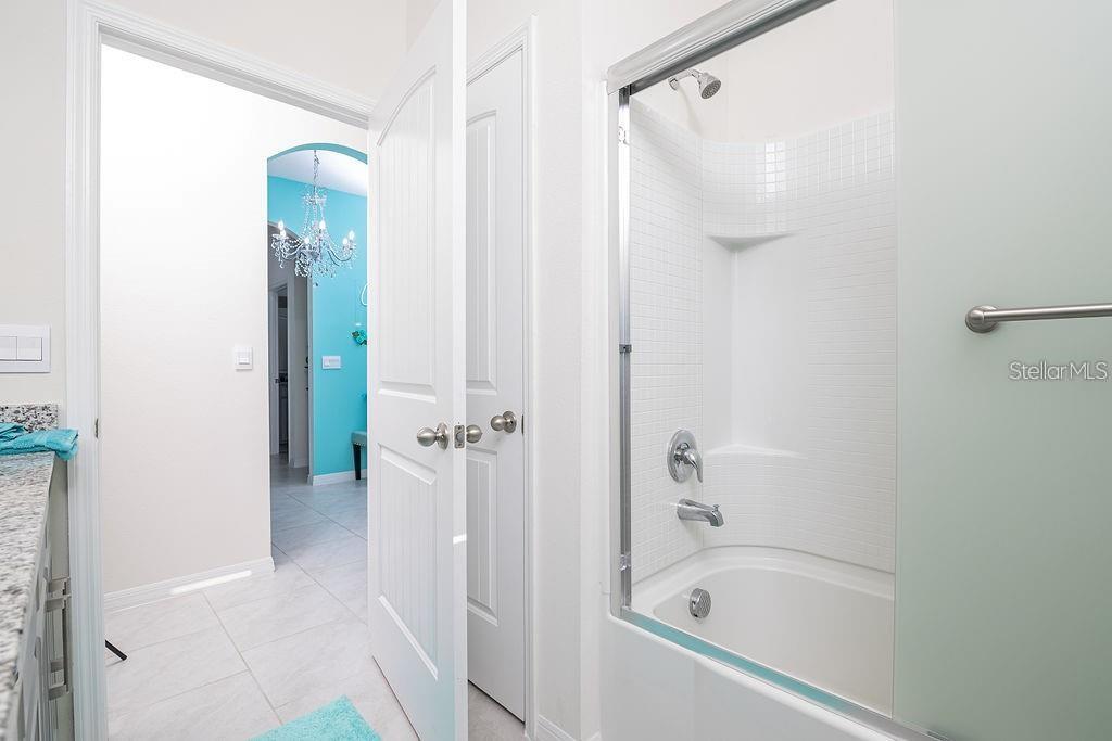 2937 Hooded Crane Cove Harmony, FL 34773 - Photo 45 of 58 a bathroom with a bathtub and shower