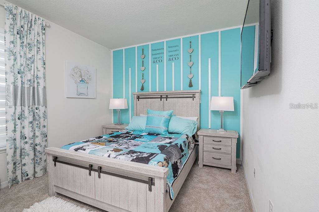 2937 Hooded Crane Cove Harmony, FL 34773 - Photo 46 of 58 a bedroom with a bed and a cabinets