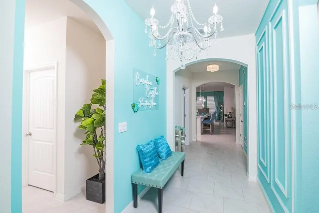 a living room with furniture and a chandelier