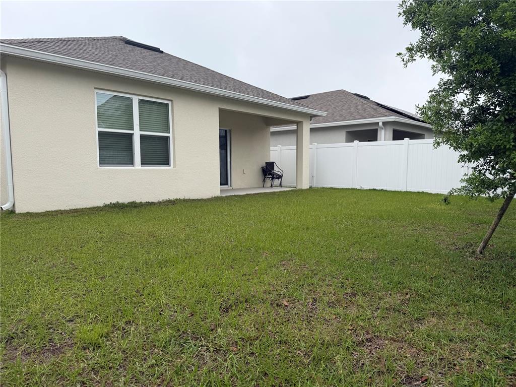 6772 Huntleigh Hammock Road St. Cloud, FL 34773 - Photo 13 of 14 a house that has a big yard with wooden fence