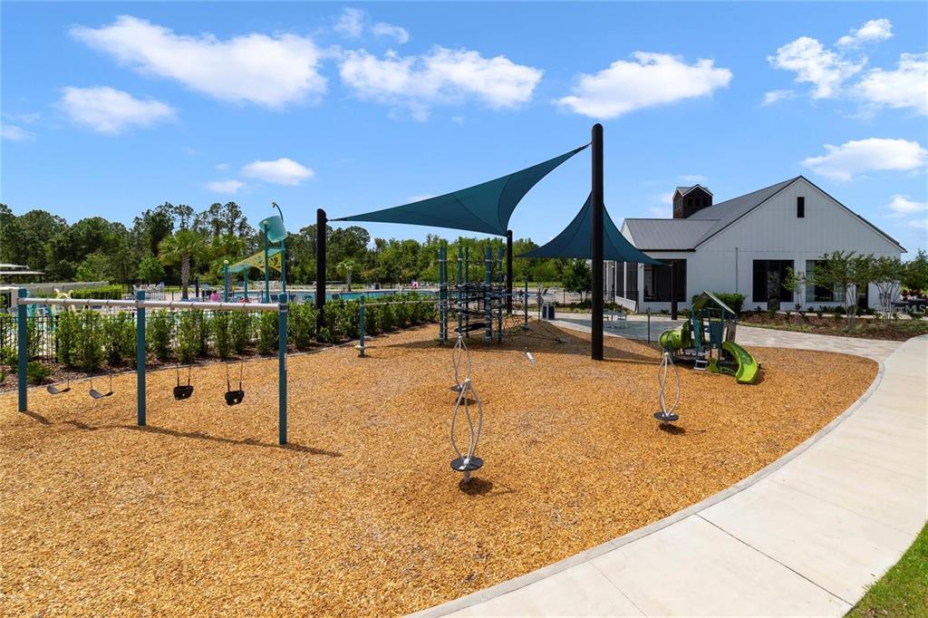 6772 Huntleigh Hammock Road St. Cloud, FL 34773 - Photo 14 of 14 a swimming pool with table and chairs