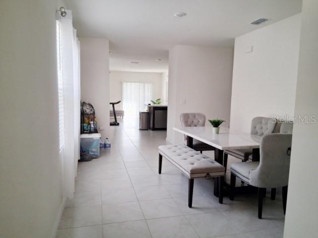 6772 Huntleigh Hammock Road St. Cloud, FL 34773 - Photo 7 of 14 a living room with furniture and a table