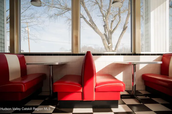 a room with chairs and a window