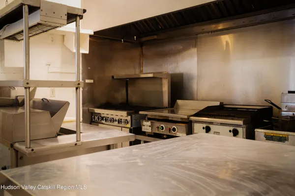 a kitchen with a sink and a stove top oven