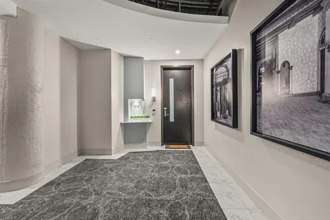 a view of a hallway with a bathroom