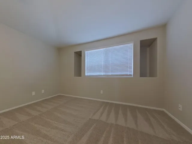a view of a kitchen with an empty space and a window