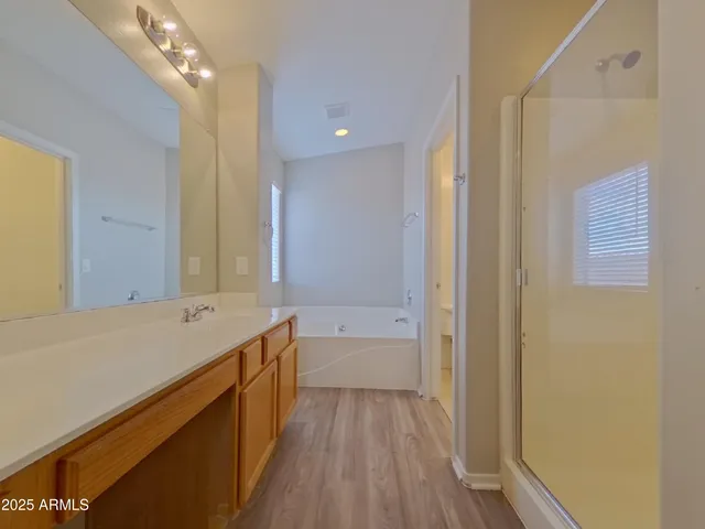 a bathroom with a tub sink and a mirror