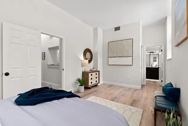 a bedroom with a bed and a dresser