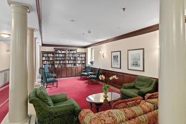 a living room with furniture and floor to ceiling window