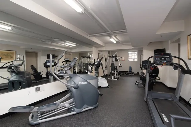 a room with gym equipment and a mirror
