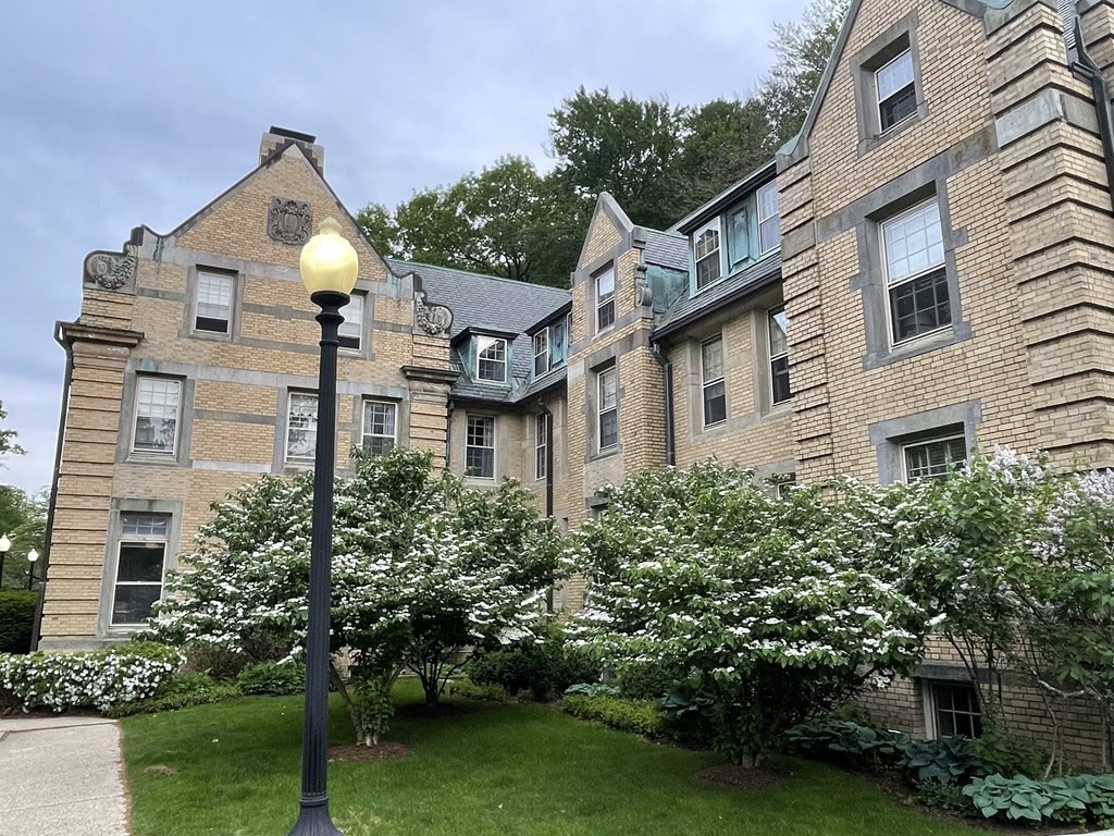 65 Glen Road, Unit H2 Brookline, MA 02445 - Photo 32 of 34 a front view of a house with a yard and potted plants